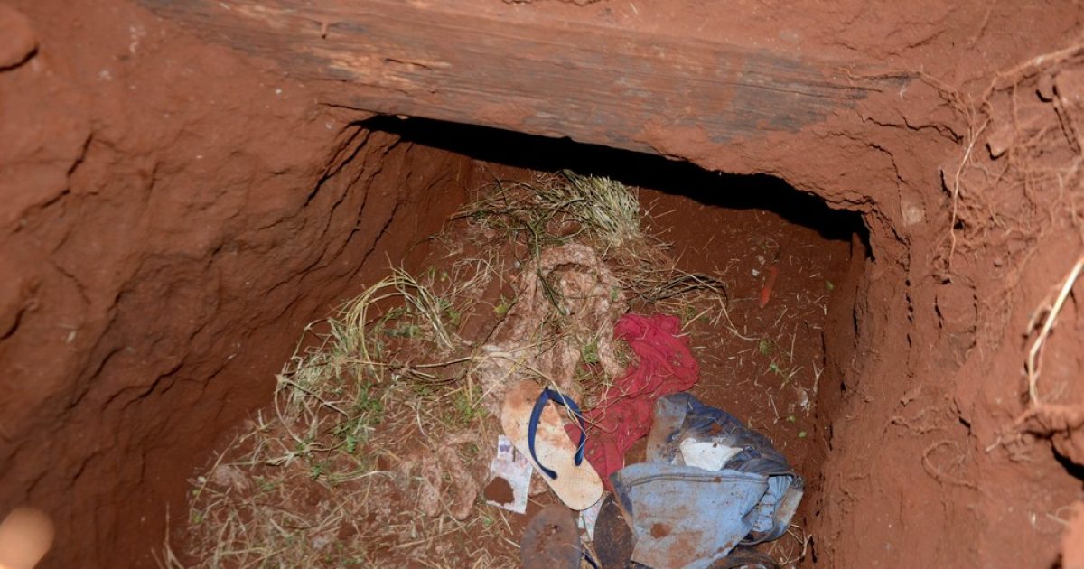 Roupas são vistas na entrada de um túnel na prisão de Pedro Juan Caballero, no Paraguai, por onde dezenas de presos fugiram na manhã deste domingo (19) — Foto: Marciano Candia/AP